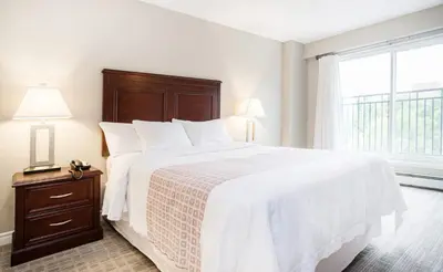 a bedroom with a large bed and a window at Canterra Suites Hotel in Edmonton