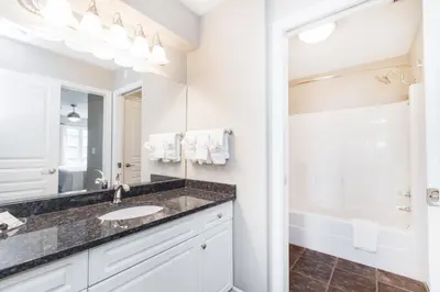 a bathroom with a sink and a mirror at Canterra Suites Hotel in Edmonton