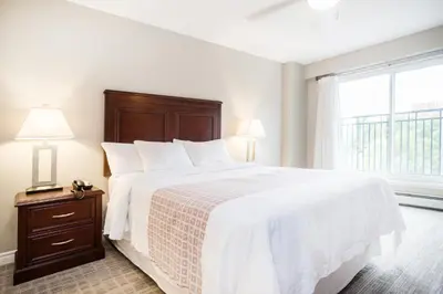 a bedroom with a large bed and a window at Canterra Suites Hotel in Edmonton