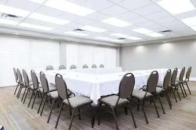 a conference room with a long table and chairs at Canterra Suites Hotel in Edmonton