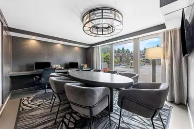 a dining room with a table and chairs at Best Western Plus Banff International Lodge in Banff