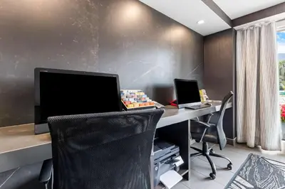 an office with a desk with a computer and two chairs at Best Western Plus Banff International Lodge in Banff
