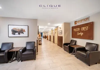 a waiting room with chairs and tables in a hospital at Falcon Crest Lodge by CLIQUE in Canmore