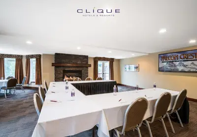 a conference room with a large table and chairs at Falcon Crest Lodge by CLIQUE in Canmore
