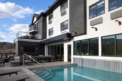 a house with a swimming pool and a building at Doubletree By Hilton West Kelowna in West Kelowna
