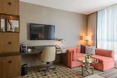 a hotel room with a couch and a desk at Loden Vancouver in Vancouver