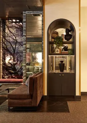a living room with a couch and a mirror at Loden Vancouver in Vancouver