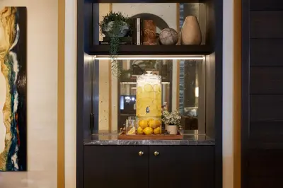 a cabinet with a display of fruit on a shelf at Loden Vancouver in Vancouver