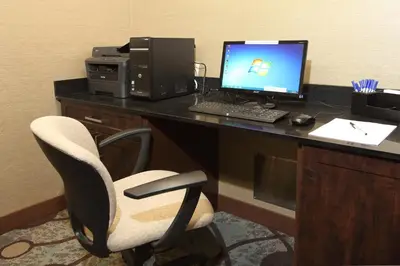 an office with a desk with a computer and a chair at Holiday Inn Express Hotel & Suites Vernon by IHG in Vernon