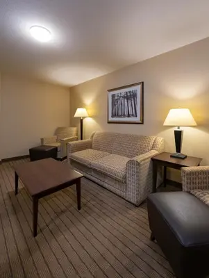 a living room with a couch and a table at Bayview Hotel in Courtenay