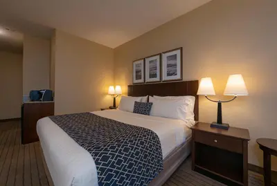 a hotel room with a large bed and two lamps at Bayview Hotel in Courtenay