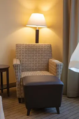 a chair with a lamp in a hotel room at Bayview Hotel in Courtenay