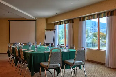 a conference room with a long table and chairs at Holiday Inn Hotel & Suites Osoyoos by IHG in Osoyoos