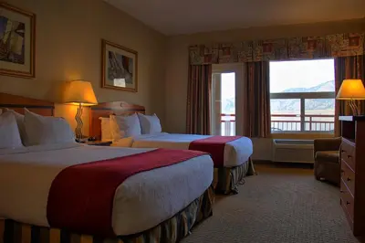 a hotel room with two beds and a window at Holiday Inn Hotel & Suites Osoyoos by IHG in Osoyoos