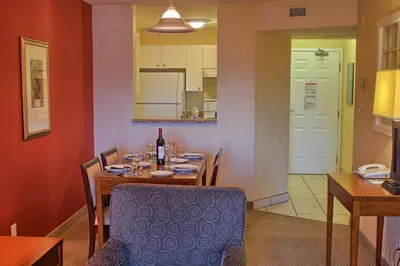a dining room with a table with a bottle of wine at Holiday Inn Hotel & Suites Osoyoos by IHG in Osoyoos