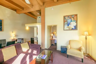 a living room with a couch and a chair at Swans Brewery, Pub & Hotel in Victoria
