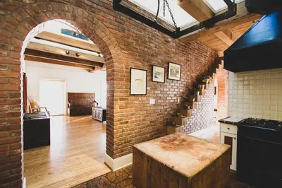 a kitchen with a brick wall and an archway at Swans Brewery, Pub & Hotel in Victoria