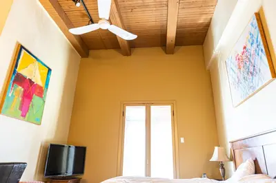 a bedroom with a ceiling fan and a tv at Swans Brewery, Pub & Hotel in Victoria