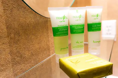 a group of four bottles of moisturizing moisturizers and a yellow box at Swans Brewery, Pub & Hotel in Victoria