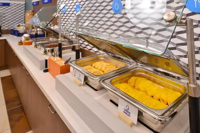 a buffet line with trays of food on display at Holiday Inn Express Hotel & Suites Edson by IHG in Edson
