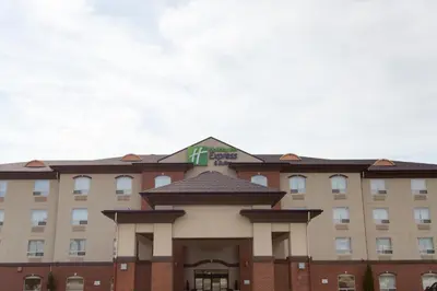 a hotel building with a sign on top of it at Holiday Inn Express & Suites Drayton Valley by IHG in Drayton Valley