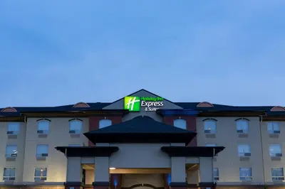 a hotel with a sign on top of a building at Holiday Inn Express & Suites Drayton Valley by IHG in Drayton Valley