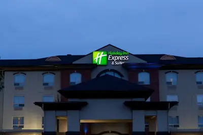 a hotel with a sign on top of a building at Holiday Inn Express & Suites Drayton Valley by IHG in Drayton Valley