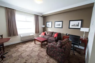 a living room with a couch and a chair at Nova Inn Manning in Manning