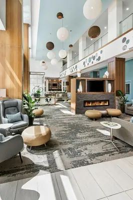 a lobby with couches and a fireplace at Element Calgary Airport in Calgary