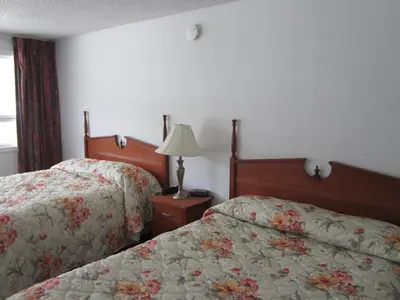 a hotel room with two beds and a lamp at Bonanza Gold Motel & RV Park in Dawson City
