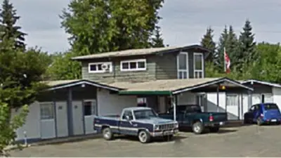 a blue truck parked in front of a house at Superlodge Lloydminster in Lloydminster