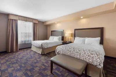 a hotel room with two beds and a window at Best Western PLUS Fox Creek in Fox Creek