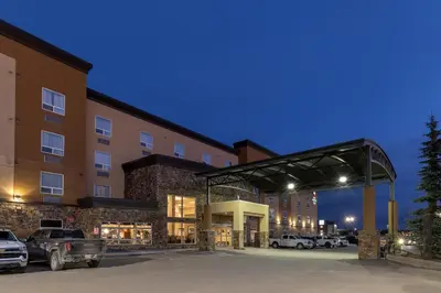 a parking lot in front of a hotel at Best Western PLUS Fox Creek in Fox Creek