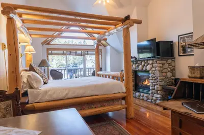 a bedroom with a bed and a fireplace at Beaujolais Boutique B&B at Thea's House- Adults Only in Banff