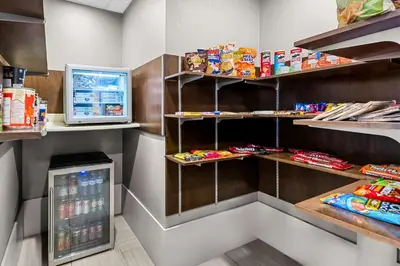 a fast food restaurant with a refrigerator and snacks at Best Western Plus Airdrie Gateway in Airdrie