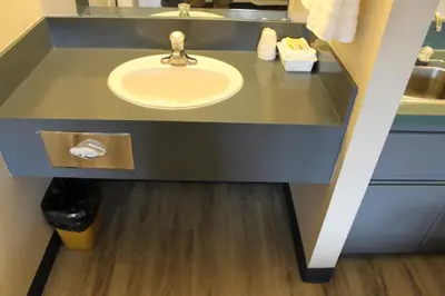 a bathroom with a sink and a mirror at Plains Motor Inn in Stettler