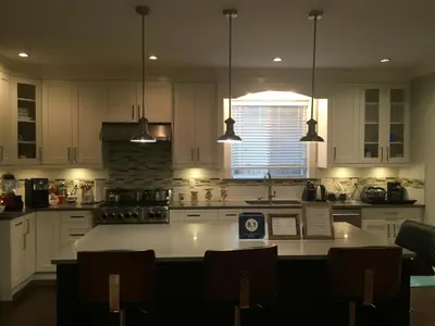 a kitchen with white cabinets and a white counter top at Vancouver Austin Guesthouse in Coquitlam