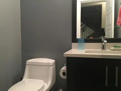 a bathroom with a white toilet and a sink at Vancouver Austin Guesthouse in Coquitlam