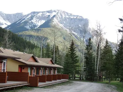 a house with a mountain in the background at Jasper Gates Resort in Jasper