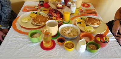 a table with a breakfast of pancakes and other foods at Overlander B&B in Kamloops