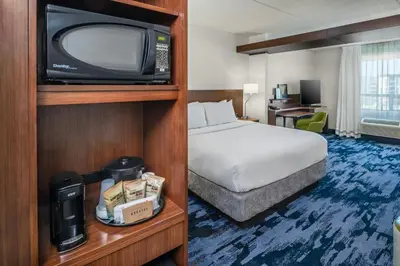 a hotel room with a bed and a tv at Fairfield Inn & Suites by Marriott Edmonton North in Edmonton