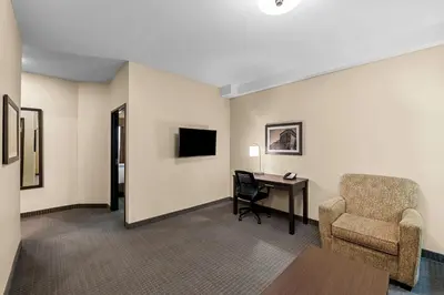 a hotel room with a desk and a chair at Best Western Plus Lacombe Inn and Suites in Lacombe
