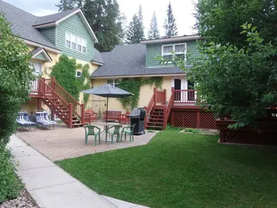a house with a patio with a table and chairs at Blaeberry Valley Vacation Rentals in Golden