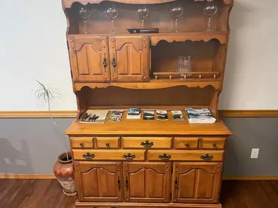 a tall wooden dresser in a room at Blaeberry Valley Vacation Rentals in Golden