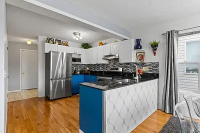 a kitchen with white cabinets and a blue counter top at 4 Bedroom 4 Bathroom 2 Kitchen House in Bridlewood in Calgary