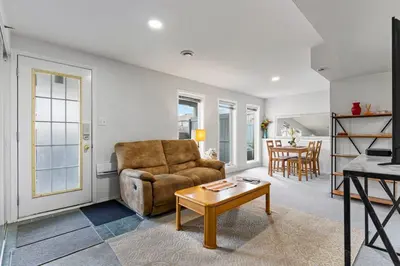a living room with a couch and a table at 4 Bedroom 4 Bathroom 2 Kitchen House in Bridlewood in Calgary