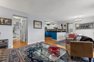 a living room with a couch and a table at 4 Bedroom 4 Bathroom 2 Kitchen House in Bridlewood in Calgary