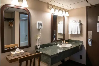 a bathroom with a sink and a large mirror at The Rundlestone Lodge in Banff