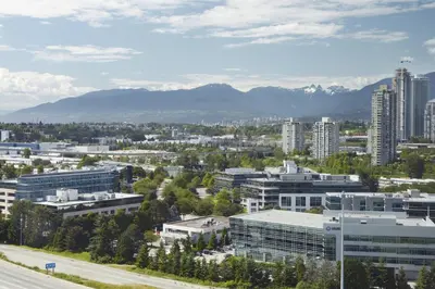 a city with buildings and mountains in the background at Delta Hotels by Marriott Burnaby Conference Centre in Burnaby