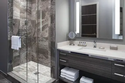 a bathroom with a sink and a shower at Delta Hotels by Marriott Burnaby Conference Centre in Burnaby